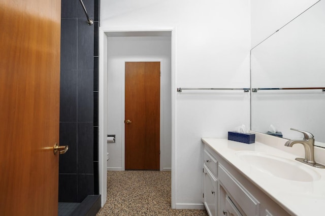 4760 N Rowell Ave, Fresno, CA 93726 - bathroom featuring vanity, a shower, and speckle patterned floor
