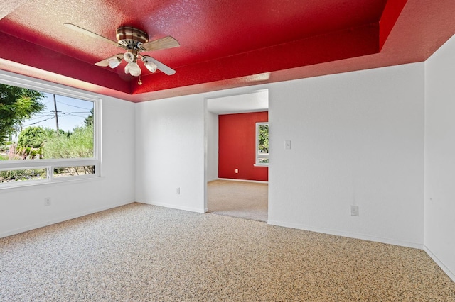 4760 N Rowell Ave, Fresno, CA 93726 - empty room with plenty of natural light, a ceiling fan, and a raised ceiling