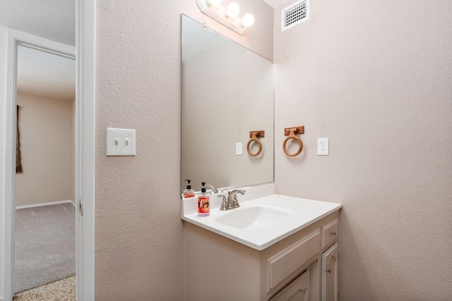 4760 N Rowell Ave, Fresno, CA 93726 - bathroom with vanity and a textured wall