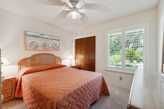 1059 E Fallbrook Ave, Fresno, CA 93720 - carpeted bedroom featuring multiple windows, a textured ceiling, ceiling fan, and a closet