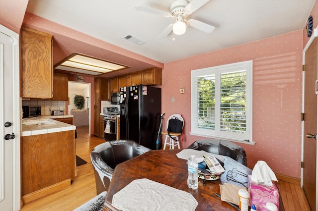 1059 E Fallbrook Ave, Fresno, CA 93720 - dining room with ceiling fan and light wood finished floors