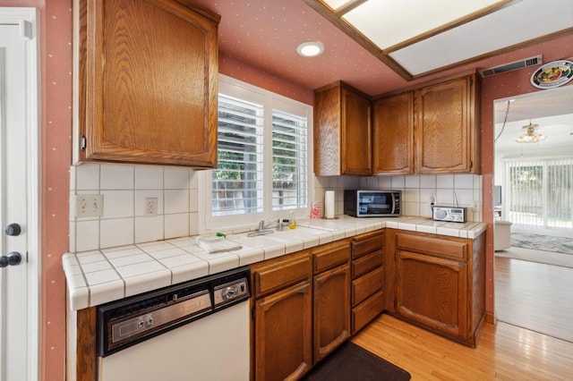 1059 E Fallbrook Ave, Fresno, CA 93720 - kitchen with white dishwasher, stainless steel microwave, light wood-style flooring, plenty of natural light, and recessed lighting