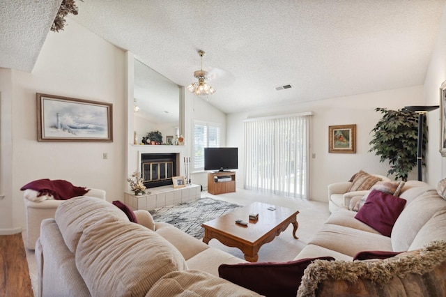 1059 E Fallbrook Ave, Fresno, CA 93720 - living room featuring a textured ceiling, lofted ceiling, and a tile fireplace