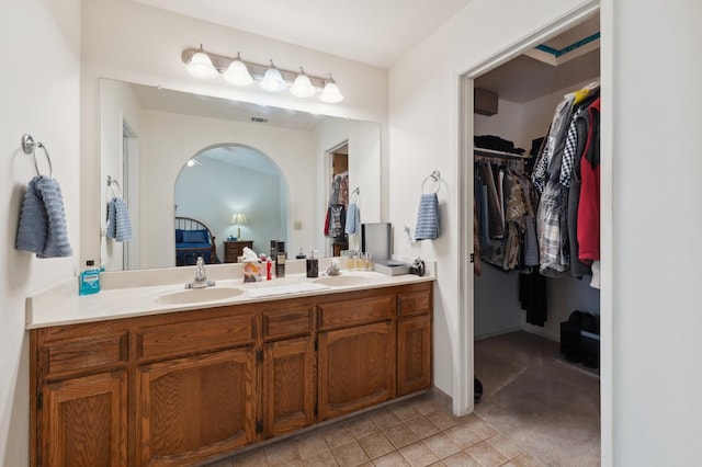 1059 E Fallbrook Ave, Fresno, CA 93720 - ensuite bathroom with double vanity, a spacious closet, and tile patterned floors