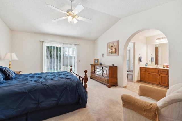 1059 E Fallbrook Ave, Fresno, CA 93720 - bedroom with access to exterior, arched walkways, light colored carpet, lofted ceiling, and ensuite bathroom
