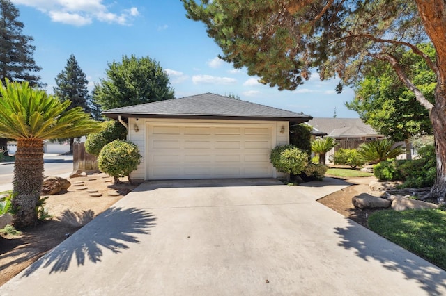 1059 E Fallbrook Ave, Fresno, CA 93720 - view of front of home with a garage and driveway