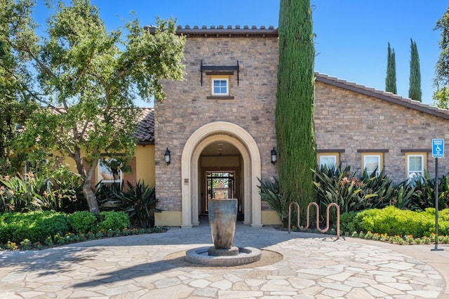 3613 Utah Ln, Clovis, CA 93619 - mediterranean / spanish-style house featuring stone siding, stucco siding, and a tile roof