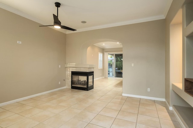 3613 Utah Ln, Clovis, CA 93619 - unfurnished living room with crown molding, ceiling fan, a fireplace, light tile patterned floors, and arched walkways