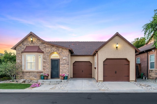 3613 Utah Ln, Clovis, CA 93619 - view of front facade with stucco siding, stone siding, a garage, and concrete driveway