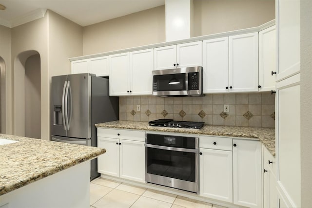 3613 Utah Ln, Clovis, CA 93619 - kitchen featuring stainless steel appliances, backsplash, white cabinets, and ornamental molding