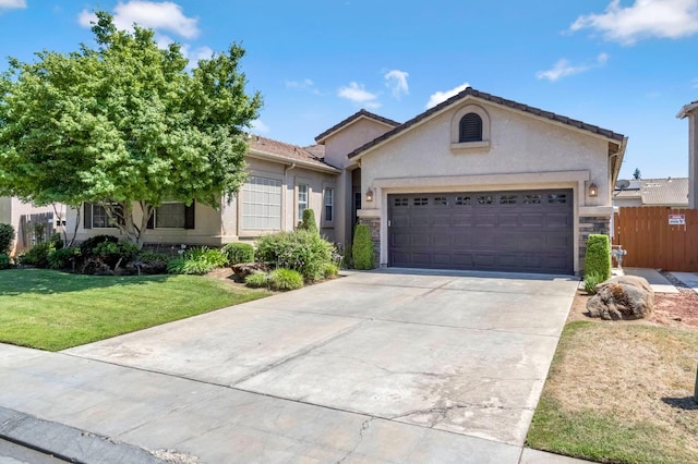 2663 E Spice Way, Fresno, CA 93720 - ranch-style house with an attached garage, concrete driveway, stucco siding, and stone siding