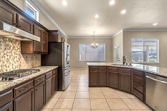 2663 E Spice Way, Fresno, CA 93720 - kitchen featuring stainless steel appliances, a chandelier, under cabinet range hood, decorative backsplash, and ornamental molding