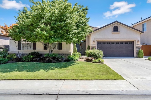 2663 E Spice Way, Fresno, CA 93720 - view of front of property with an attached garage, concrete driveway, stucco siding, and a front lawn