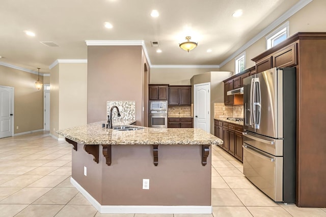 2663 E Spice Way, Fresno, CA 93720 - kitchen featuring stainless steel appliances, a breakfast bar area, light tile patterned floors, decorative backsplash, and recessed lighting