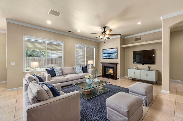 2663 E Spice Way, Fresno, CA 93720 - living area featuring light tile patterned floors, ceiling fan, a glass covered fireplace, ornamental molding, and recessed lighting