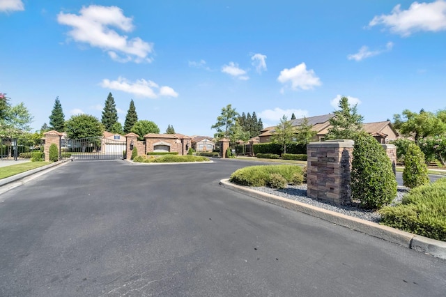 2663 E Spice Way, Fresno, CA 93720 - view of asphalt street with a gate, curbs, a residential view, and a gated entry
