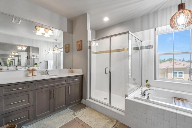 2076 Chennault Ave, Clovis, CA 93611 - bathroom featuring vanity, a shower stall, a garden tub, and tile patterned flooring