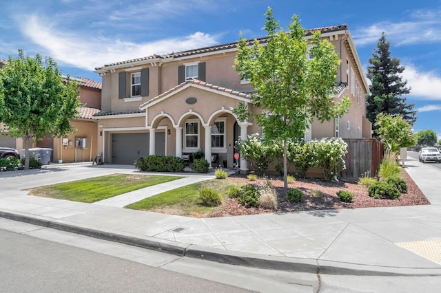 2076 Chennault Ave, Clovis, CA 93611 - mediterranean / spanish house with a garage, concrete driveway, a tile roof, and stucco siding
