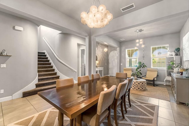 2076 Chennault Ave, Clovis, CA 93611 - dining area featuring a chandelier, light tile patterned floors, stairs, and arched walkways