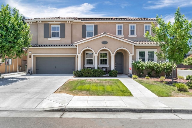 2076 Chennault Ave, Clovis, CA 93611 - mediterranean / spanish home with a tiled roof, an attached garage, stucco siding, and driveway