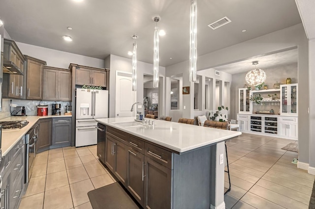 2076 Chennault Ave, Clovis, CA 93611 - kitchen with appliances with stainless steel finishes, light tile patterned floors, light countertops, and open floor plan