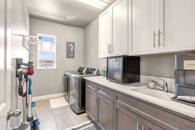 2076 Chennault Ave, Clovis, CA 93611 - laundry area featuring cabinet space, washer and clothes dryer, and light tile patterned floors