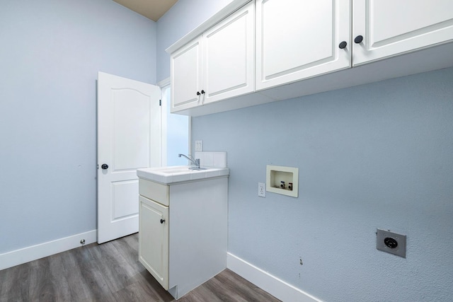 5667 W Bluff Ave, Fresno, CA 93722 - laundry room featuring electric dryer hookup, cabinet space, hookup for a washing machine, and dark wood-style floors