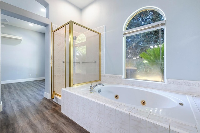 5667 W Bluff Ave, Fresno, CA 93722 - bathroom with a stall shower, a tub with jets, and wood finished floors