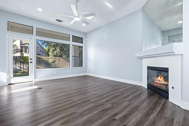 5667 W Bluff Ave, Fresno, CA 93722 - unfurnished living room with dark wood-type flooring, a tiled fireplace, recessed lighting, and a ceiling fan