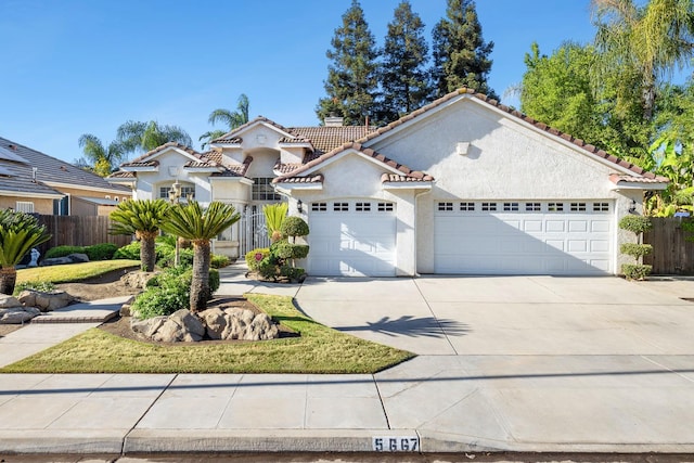 5667 W Bluff Ave, Fresno, CA 93722 - mediterranean / spanish house featuring stucco siding, a garage, driveway, a tiled roof, and a chimney