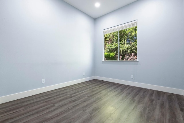 5667 W Bluff Ave, Fresno, CA 93722 - empty room with dark wood-style floors and recessed lighting