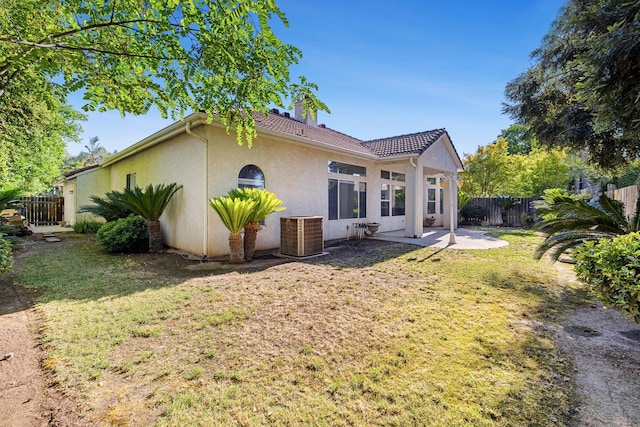 5667 W Bluff Ave, Fresno, CA 93722 - rear view of house featuring stucco siding, a patio, and a chimney