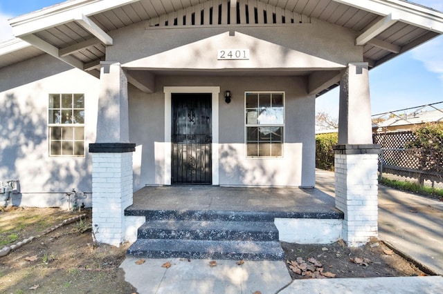 2401 E Hedges Ave, Fresno, CA 93703 - doorway to property featuring stucco siding and covered porch