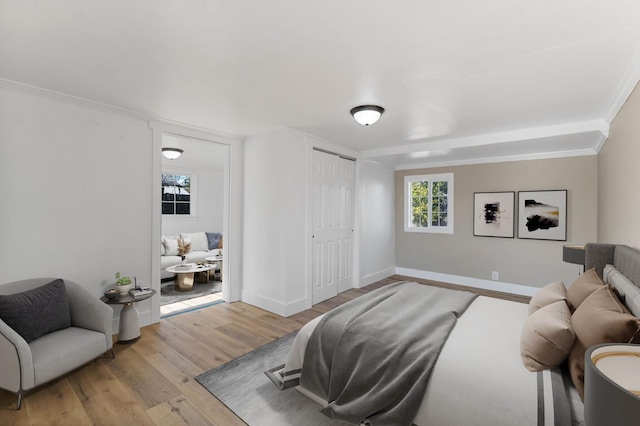 2401 E Hedges Ave, Fresno, CA 93703 - bedroom featuring light wood-style floors, a closet, and ornamental molding
