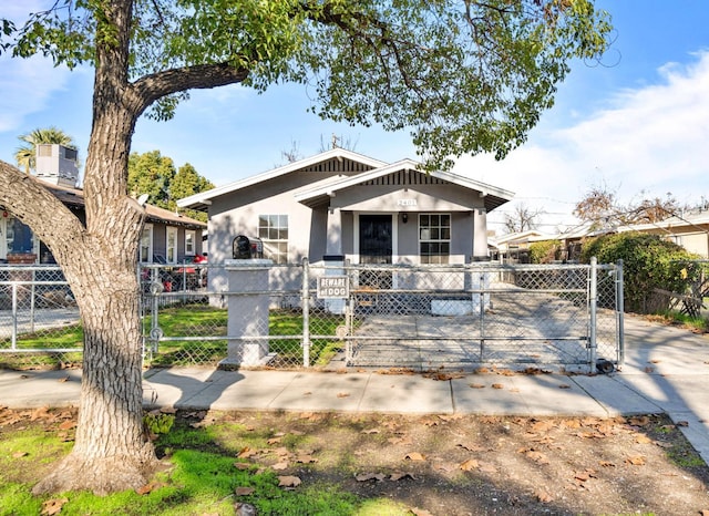 2401 E Hedges Ave, Fresno, CA 93703 - view of front facade featuring a fenced front yard, a gate, and stucco siding