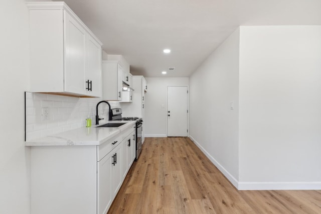 1931 W Ashlan Ave, Fresno, CA 93705 - kitchen featuring gas stove, light wood-style floors, white cabinets, tasteful backsplash, and recessed lighting