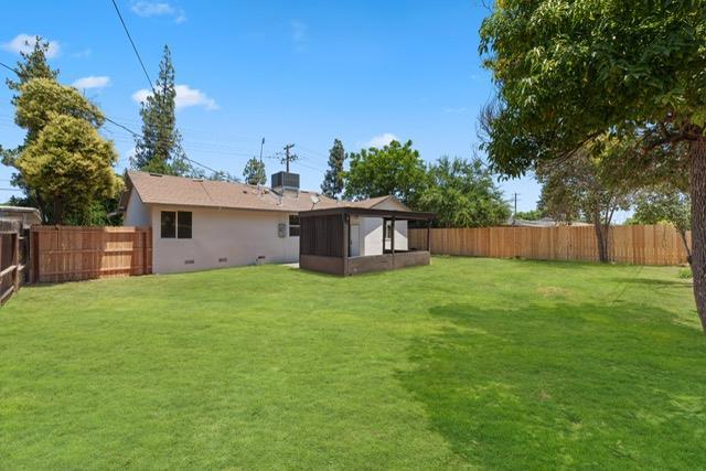 1931 W Ashlan Ave, Fresno, CA 93705 - rear view of property with a sunroom and a fenced backyard