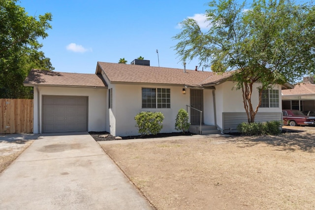 1931 W Ashlan Ave, Fresno, CA 93705 - single story home with stucco siding, an attached garage, driveway, and a shingled roof