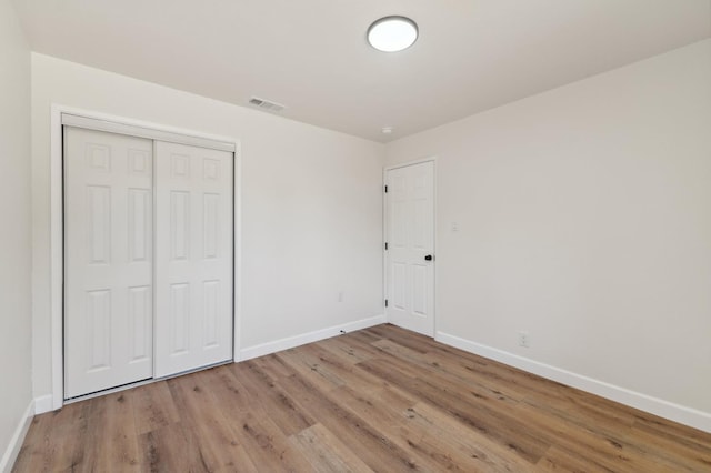 1931 W Ashlan Ave, Fresno, CA 93705 - unfurnished bedroom featuring wood finished floors and a closet