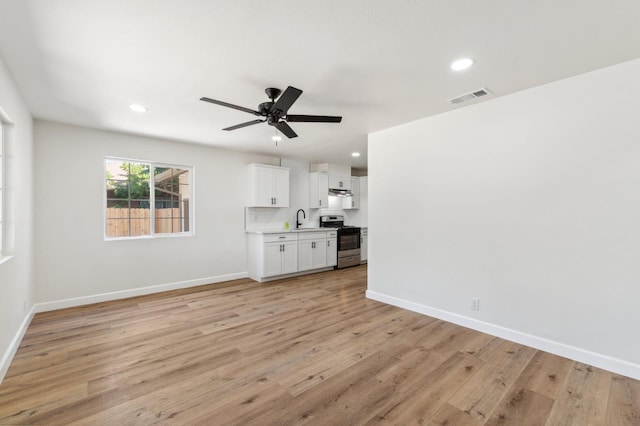 1931 W Ashlan Ave, Fresno, CA 93705 - unfurnished living room with a ceiling fan, light wood-style floors, and recessed lighting