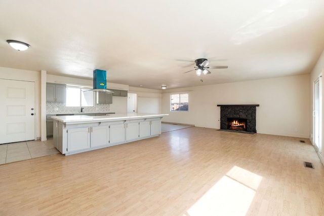 2738 S Fairway Ct, Visalia, CA 93277 - kitchen with light wood-style floors, ceiling fan, extractor fan, and light countertops