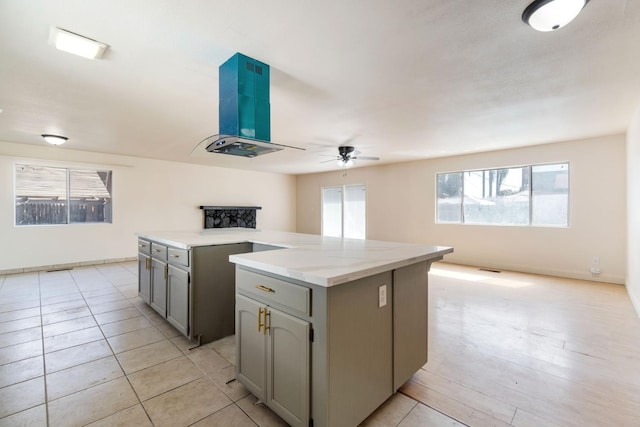 2738 S Fairway Ct, Visalia, CA 93277 - kitchen featuring gray cabinets, a kitchen island, ceiling fan, and open floor plan