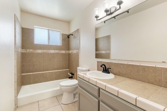 2738 S Fairway Ct, Visalia, CA 93277 - full bathroom with vanity, tub / shower combination, tile patterned flooring, and decorative backsplash