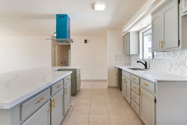 2738 S Fairway Ct, Visalia, CA 93277 - kitchen featuring extractor fan, tasteful backsplash, light stone countertops, light tile patterned floors, and gray cabinetry