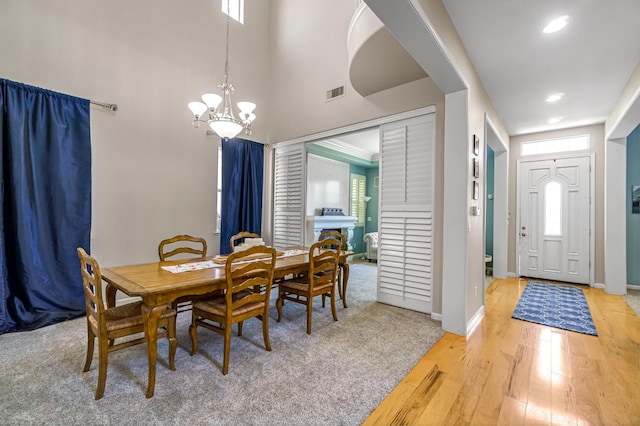 2143 Everglade Ave, Clovis, CA 93619 - dining space with a chandelier, light wood finished floors, a high ceiling, and recessed lighting