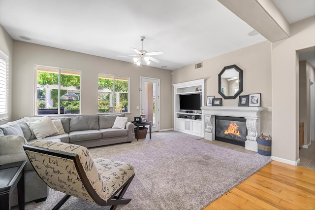 2143 Everglade Ave, Clovis, CA 93619 - living area with ceiling fan, wood finished floors, and a fireplace with flush hearth
