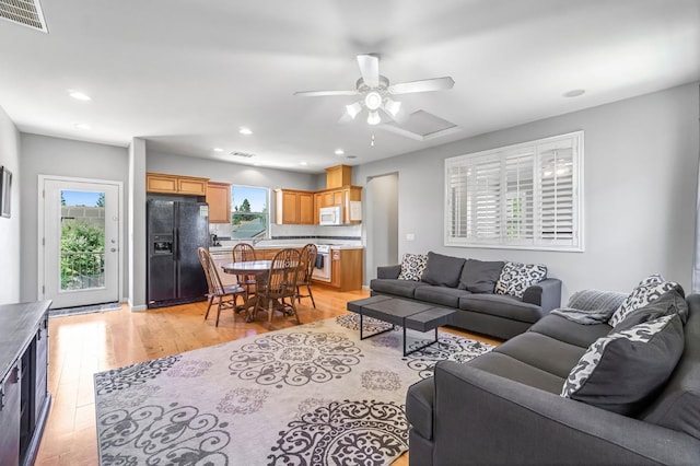 2143 Everglade Ave, Clovis, CA 93619 - living room with light wood-style floors, a ceiling fan, and recessed lighting