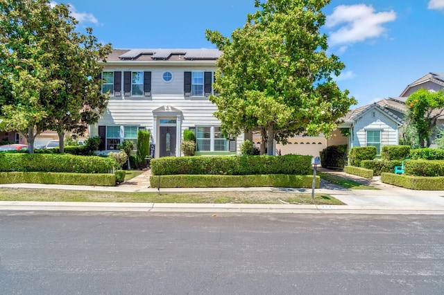 2143 Everglade Ave, Clovis, CA 93619 - view of front of house with concrete driveway, roof mounted solar panels, and an attached garage