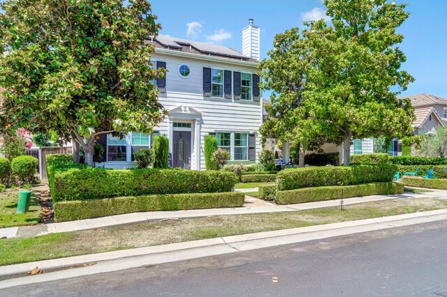 2143 Everglade Ave, Clovis, CA 93619 - view of front of home featuring roof mounted solar panels and a chimney