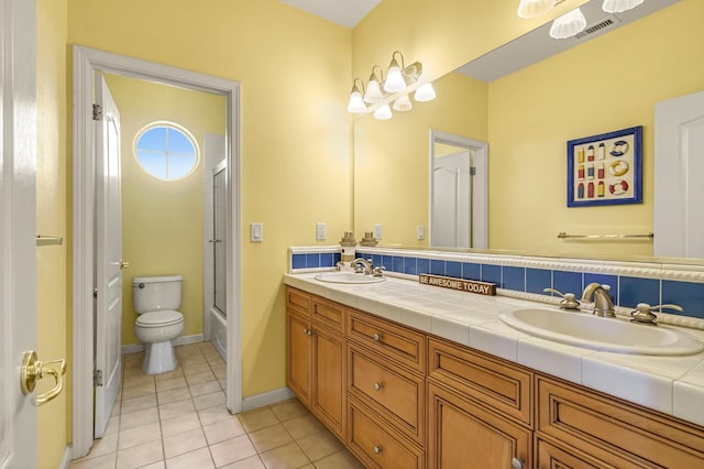 2143 Everglade Ave, Clovis, CA 93619 - bathroom with double vanity, tile patterned floors, and shower / bath combination with glass door